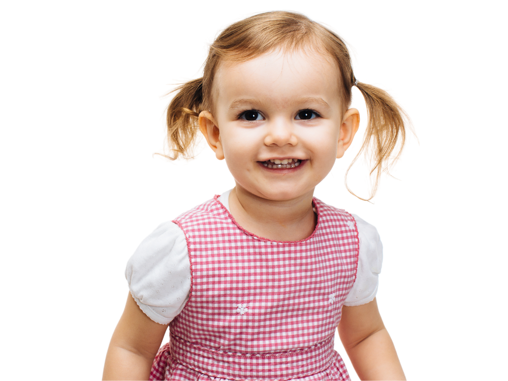 A smiling young girl with pigtails, wearing a red and white checked dress.