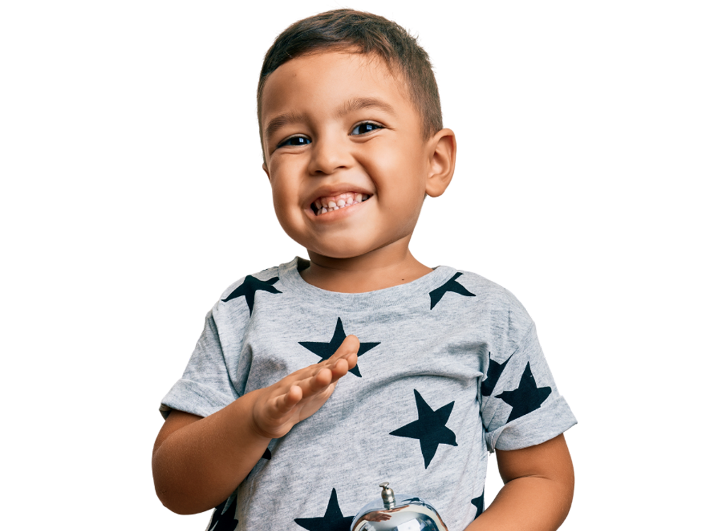 A cheerful young boy waving, wearing a gray shirt with star patterns and showing a big smile.